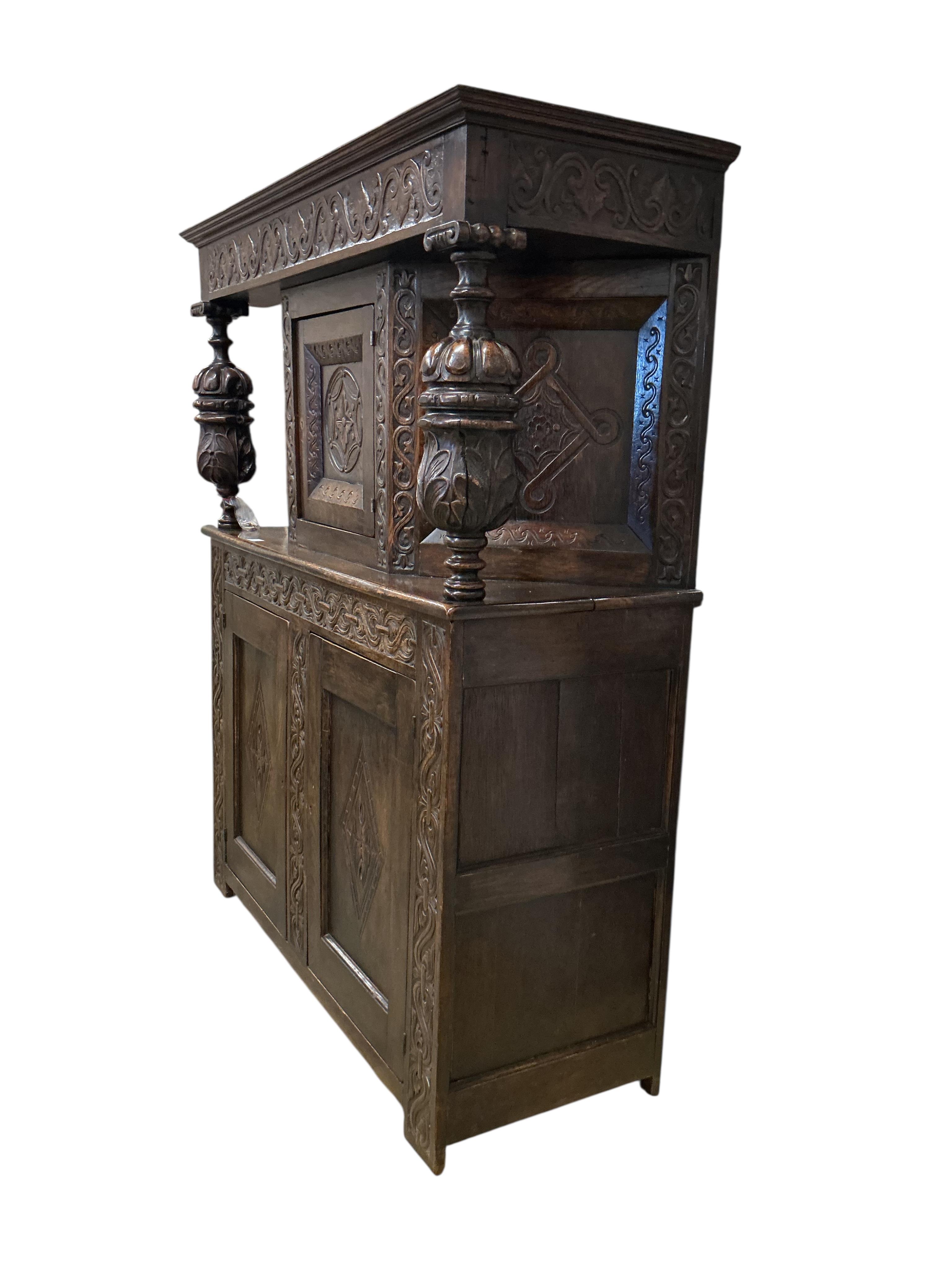 A 17th century style carved oak court cupboard, width 142cm, depth 53cm, height 176cm